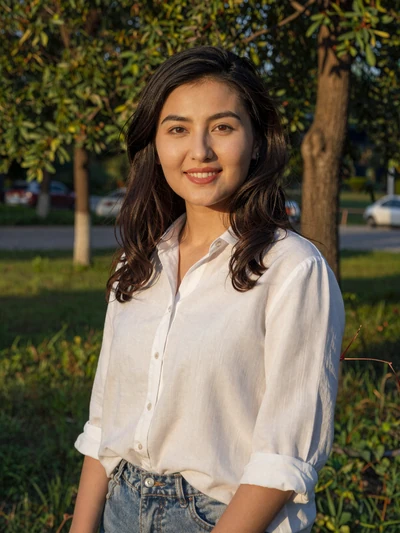 Aida Sultanova, a 27-year-old Kyrgyz woman from Bishkek smiling in a park - Kyrgyz women dating profile