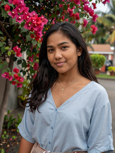 Celina da Costa, a 26-year-old Timorese woman from Dili smiling in a tropical garden - Timorese women dating profile