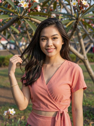 Dala Souvannavong, a 27-year-old Laotian woman from Vientiane in a frangipani garden - Laotian women dating profile