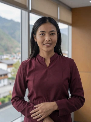 Yangzom Dorji, a 30-year-old Bhutanese woman from Mongar in a modern office with mountain views - Bhutanese women dating profile