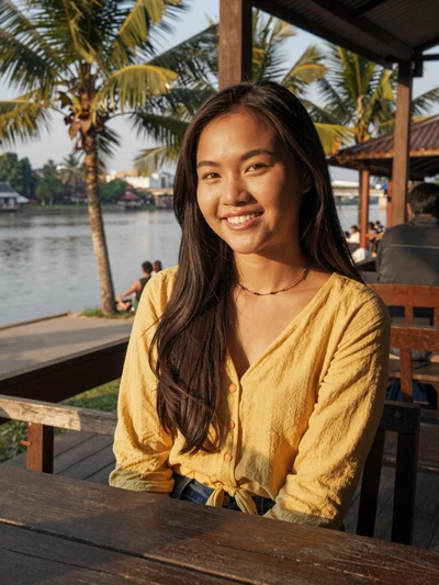 Noy Xaiyavong, a 24-year-old Laotian woman from Luang Prabang at a riverside restaurant - Laotian women dating profile