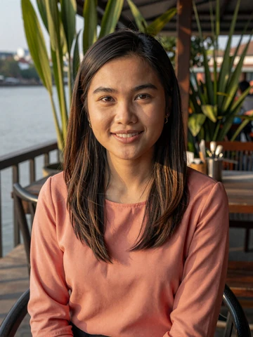 Smiling Laotian woman at a riverside cafe in Vientiane - Laotian women dating profile on FloridaDatingService