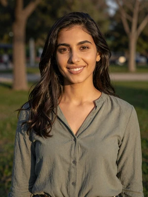 Lina Haddad, a 27-year-old Jordanian woman from Amman smiling in a park - Jordanian women dating profile